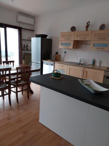 a kitchen with a black counter top and a table at CAR' MARE d'ANTIOCO in Ulassai
