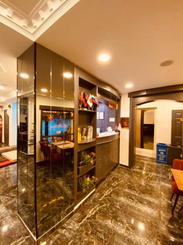 a living room with a table and a glass wall at Adora Hotel in Istanbul