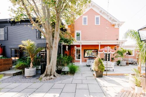 a house with a tree and a patio at American Beech Hotel in Greenport