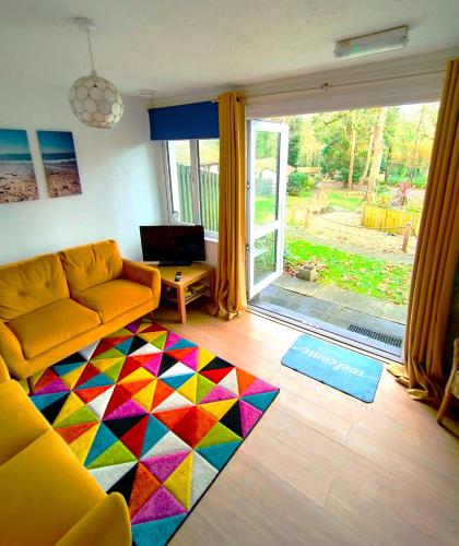 a living room with a couch and a colorful rug at Kerenza Cottage - Families & Pets in Uny Lelant