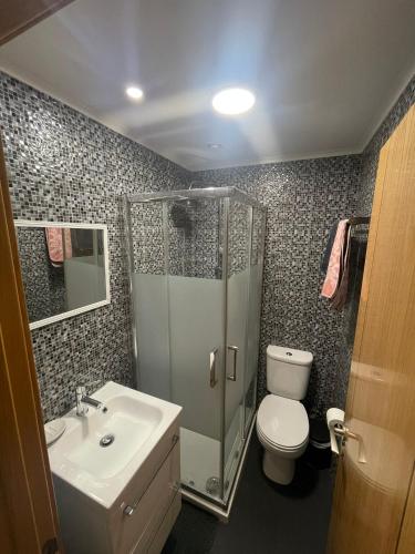 a bathroom with a shower and a toilet and a sink at Montijo Lux & Design Apartment in Montijo