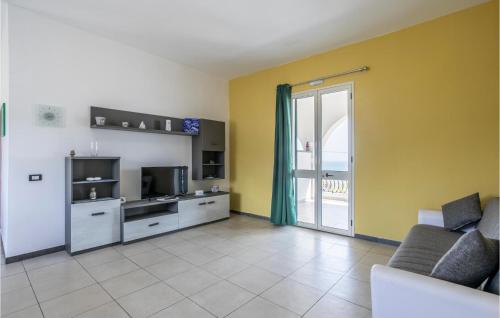 a living room with a couch and a tv and a kitchen at 8 Bedroom Gorgeous Home In Cava D'aliga in Cava dʼAliga