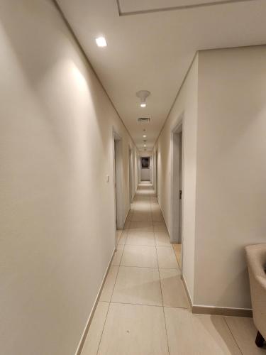 an empty hallway with white walls and a long corridor at Solo RealtyHH Apartments - Address Residence Fujairah in Sharm