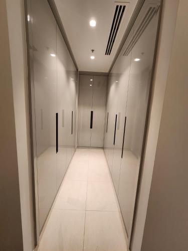 a hallway with glass doors in a building at Solo RealtyHH Apartments - Address Residence Fujairah in Sharm
