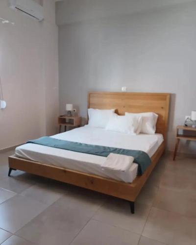 a bedroom with a large bed with a wooden headboard at Petries Apartment in Petriaí