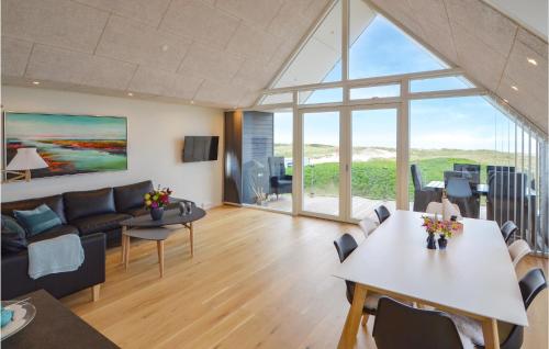 a living room with a couch and a table at Two-Bedroom Apartment In Thisted in Thisted