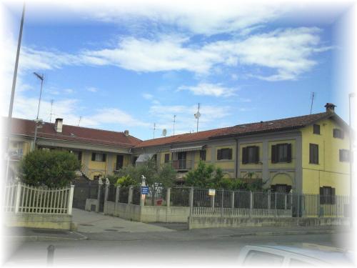a yellow house with a fence in front of it at B&B Cascina Barolo in Turin