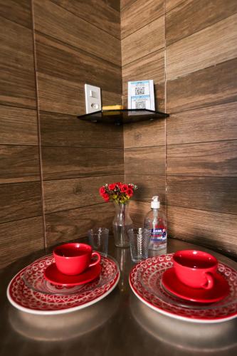 two red plates and red bowls on a table at The Best - Ponta Verde in Maceió