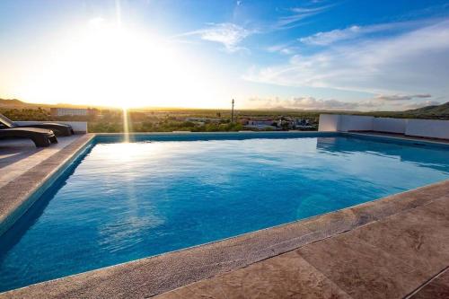 a large swimming pool on top of a building at Cabo Cottage Bahia del Tezal in Cabo San Lucas