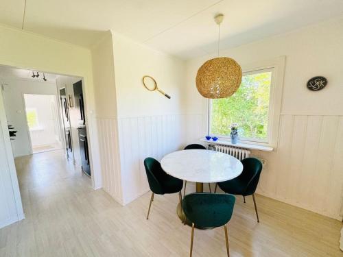 a room with a table and chairs and a window at Villa Solborg in Mölnlycke