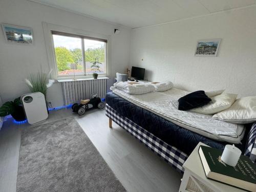 a bedroom with two beds and a window at Villa Solborg in Mölnlycke