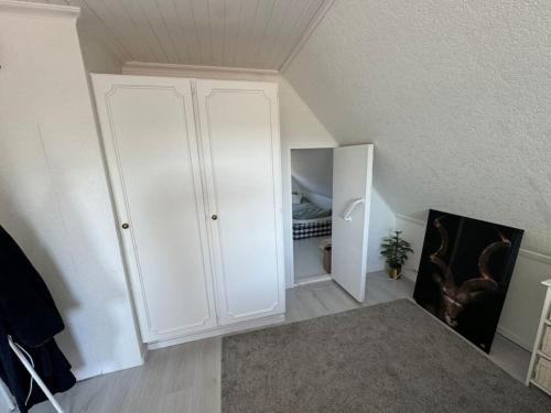 a room with a white cabinet in a attic at Villa Solborg in Mölnlycke