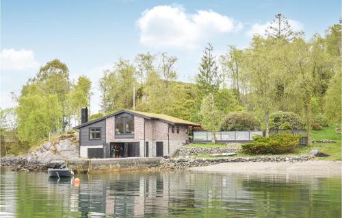 a house on the shore of a body of water at 3 Bedroom Amazing Home In Skjold in Skjold