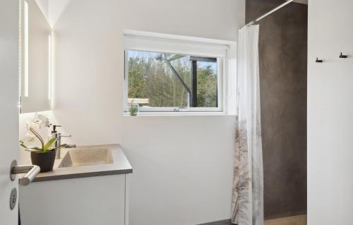 a white bathroom with a sink and a window at Gorgeous Home In Hjerm With Kitchen in Hjerm