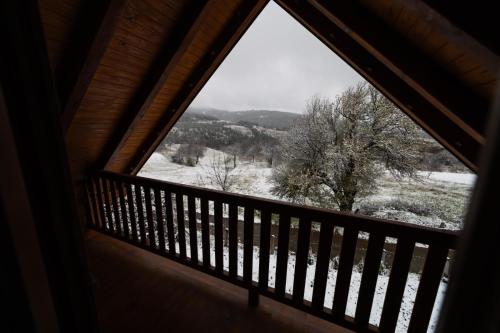 a window view of a snow covered field from a cabin at Brvnara Nina in Kremna