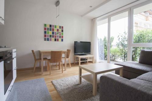 a living room with a couch and a table at Appartements Christophorus in Bad Hofgastein