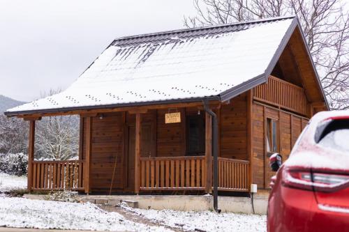 a log cabin with snow on the roof at Brvnara Nina in Kremna