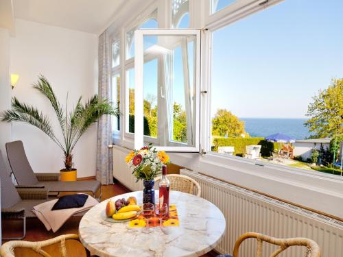 a table with fruit on it in a room with a window at Apartment Feodora in Sassnitz