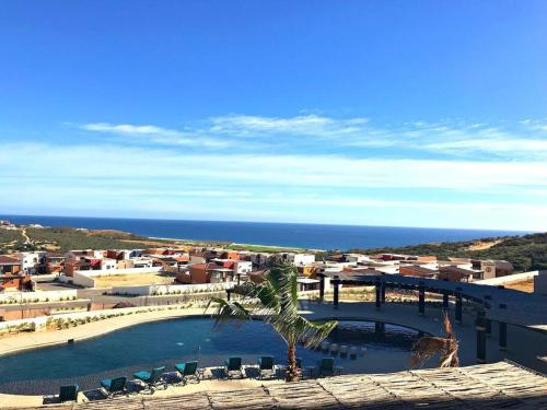 a view of a resort with a swimming pool and the ocean at Cabo Cottage Copala · Stunning * Luxury Ocean View 2BR*Resort Living in Cabo San Lucas