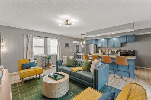 a living room with a couch and a kitchen at 3BD Family Retreat - 4 Mins to UND - Yard Games in South Bend