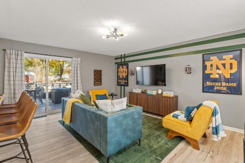 a living room with a couch and chairs and a television at 3BD Family Retreat - 4 Mins to UND - Yard Games in South Bend
