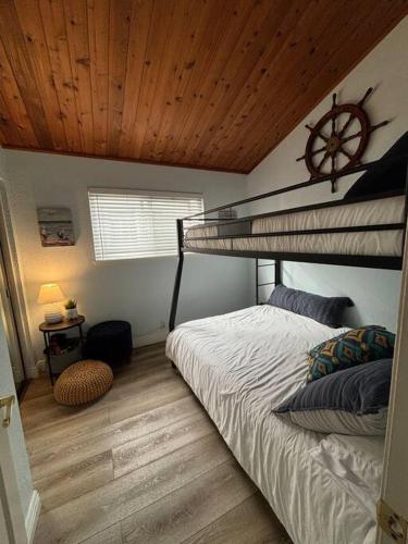 a bedroom with a bunk bed with a clock on the ceiling at Newport Beach Rendezvous in Newport Beach