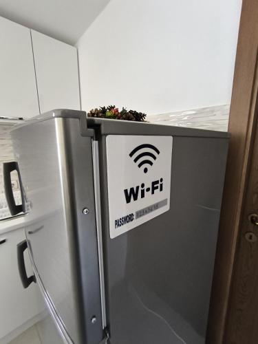a refrigerator with a wifi sign on it at Mountain House - Brezovica in Brezovicë