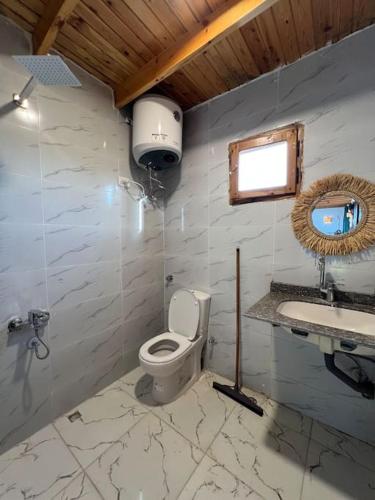 a bathroom with a toilet and a sink at A sunny Bohemian chalet in Dahab in Dahab