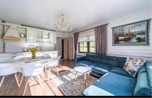 a living room with a blue couch and a table at Hara Beach house in Hara