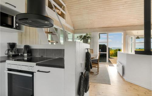 a kitchen with white counters and a stove top oven at Stunning Home In Knebel With Sauna in Knebel