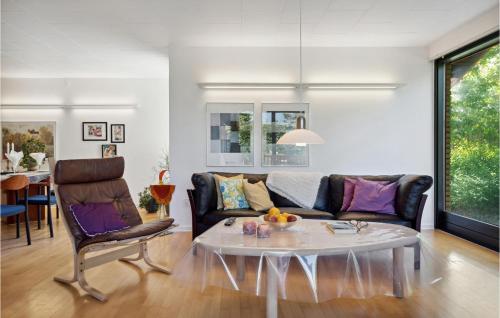 a living room with a couch and a table at 3 Bedroom Cozy Home In Risskov in Risskov