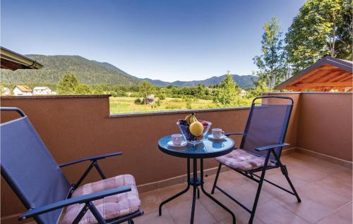 a table with a bowl of fruit on a balcony at One-Bedroom Apartment In Ogulin in Jasenak