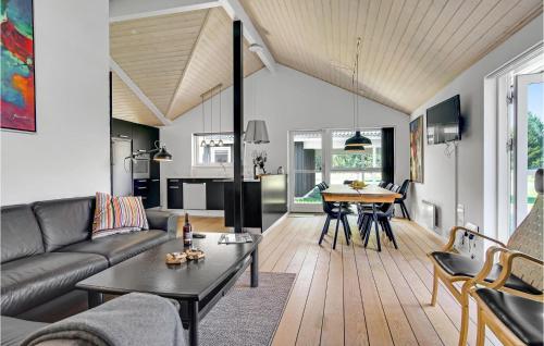 a living room with a couch and a table at Cozy Home In Jerup With Sauna in Jerup