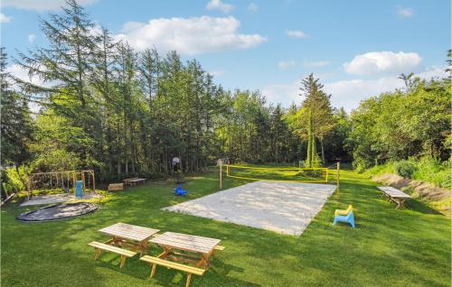 a park with two picnic tables and a playground at 5 Bedroom Amazing Home In Herning in Herning