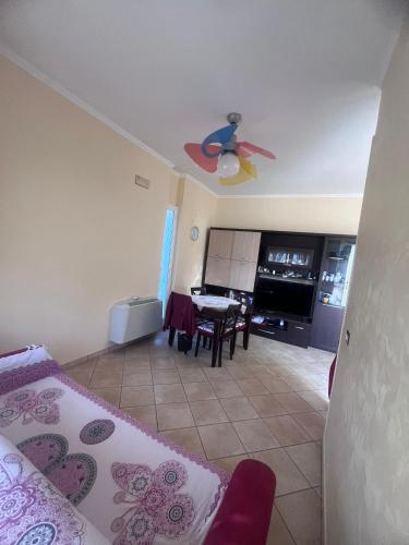 a room with a bedroom with a bed and a table at Arcobaleno 6 in Anzio