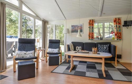 a living room with a table and two chairs at Two-Bedroom Holiday Home In Ringkobing in Ringkøbing