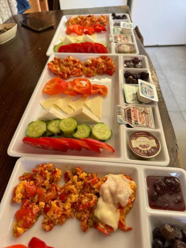 a tray filled with different types of food on a table at Karaöz Ada Bungalows & Villa in Karaoz