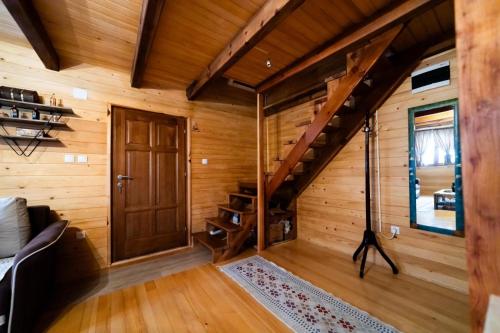 a room with a wooden staircase in a log cabin at Brvnara Nina in Kremna