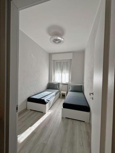 a bedroom with two beds and a window at B&B Stella in Somma Lombardo