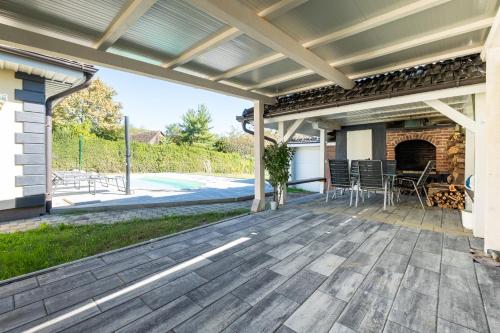 an outdoor deck with a pergola and a fireplace at Aurelia in Ðurđekovec
