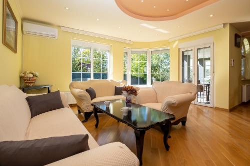 a living room with couches and a table at Aurelia in Ðurđekovec