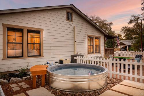 a hot tub in the yard of a house at LeMay Haus - Fire Pit, Heated Pool & Close to Main in Fredericksburg