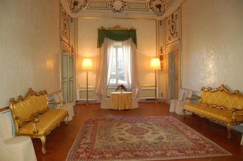 a room with two chairs and a table and a window at Palazzo Tucci Residenza d'epoca in Lucca