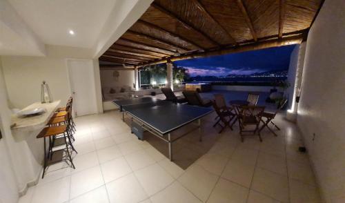 a dining room with a table and some chairs at Penthouse en Las Brisas Acapulco in Acapulco