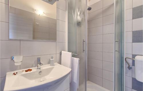 a white bathroom with a sink and a shower at Villa Ivka in Pula