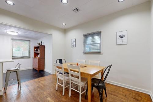 a dining room with a wooden table and chairs at Marvin's Manor in Stillwater