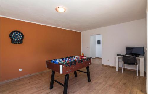 a room with a foosball table in the middle of a room at Villa Ivka in Pula