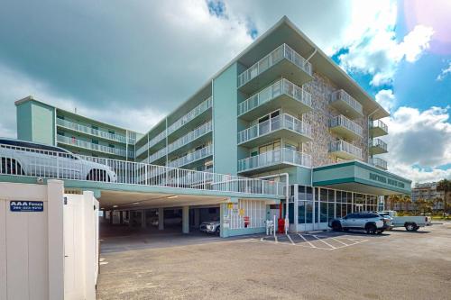 a large building with a car parked in a parking lot at Beach Bliss in Daytona Beach