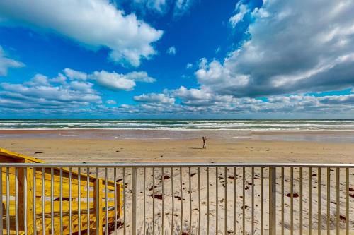 a person standing on a beach with the ocean at Beach Bliss in Daytona Beach