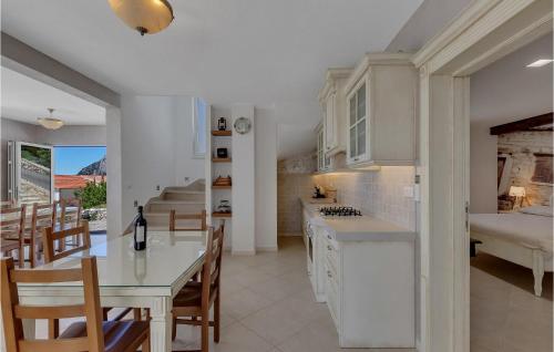 a kitchen and dining room with a table and chairs at Villa Prestige in Baška Voda